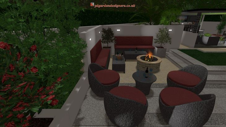 Outdoor patio with seating around a fire pit, red cushions, dark furniture, and greenery.