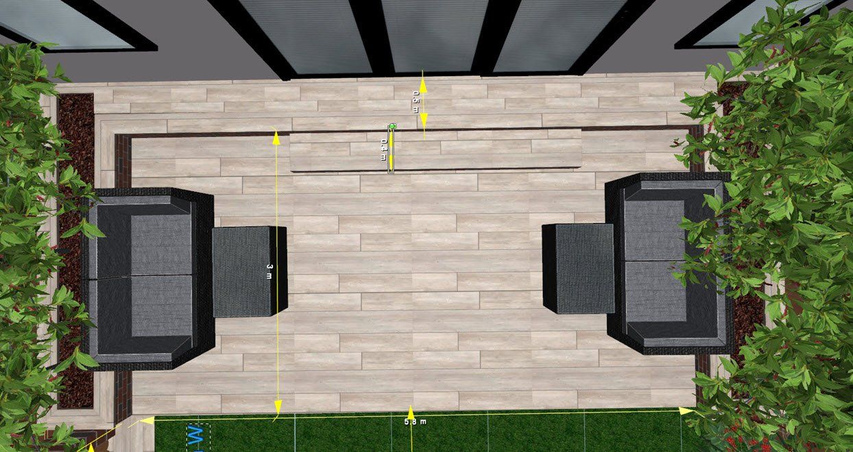 Overhead view of outdoor patio with two black couches, wooden flooring, and trees.