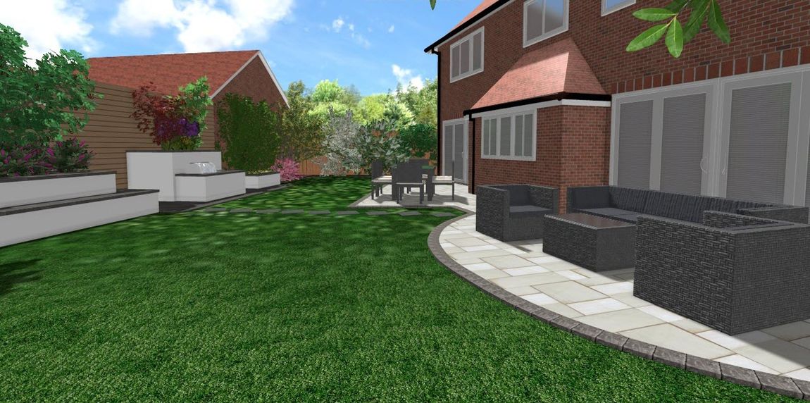 A backyard with patio furniture, green grass, a red brick house, and a light blue sky.