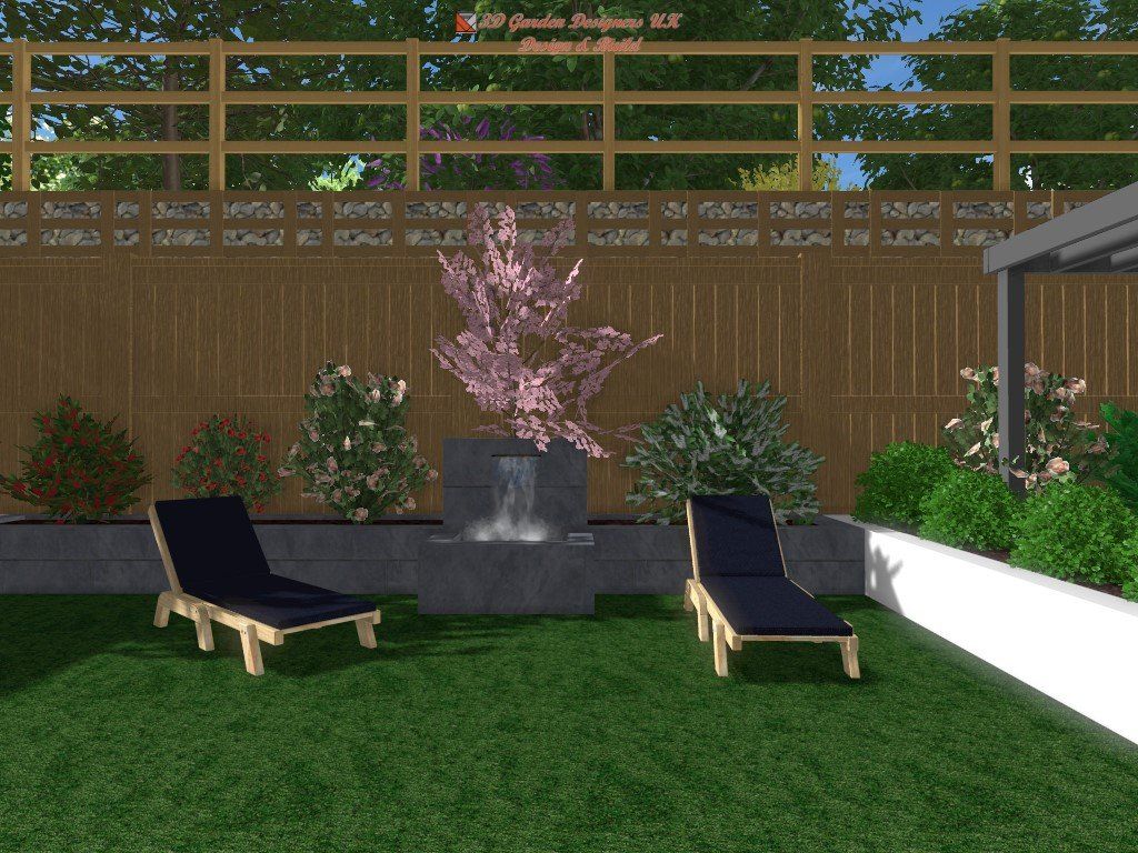 Two lounge chairs on green lawn, facing a water feature in a backyard.