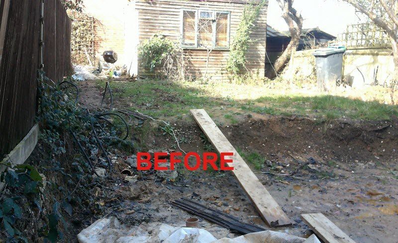 A messy, unkempt backyard with a weathered shed and exposed soil; the word 