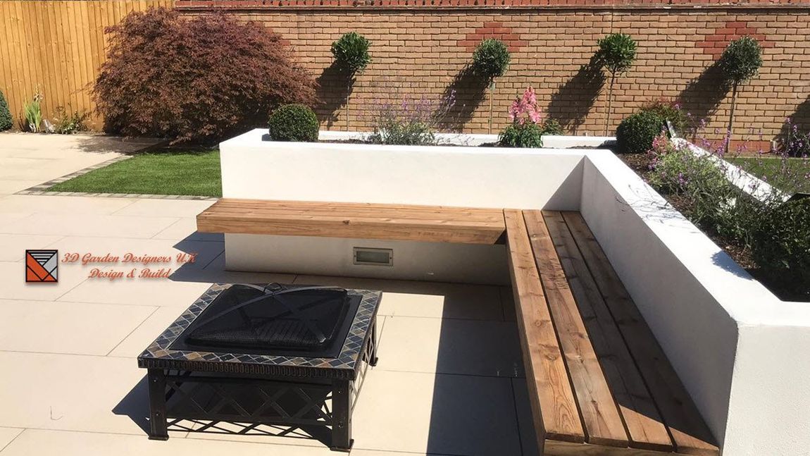 A modern outdoor space with a built-in wooden bench and a fire pit.