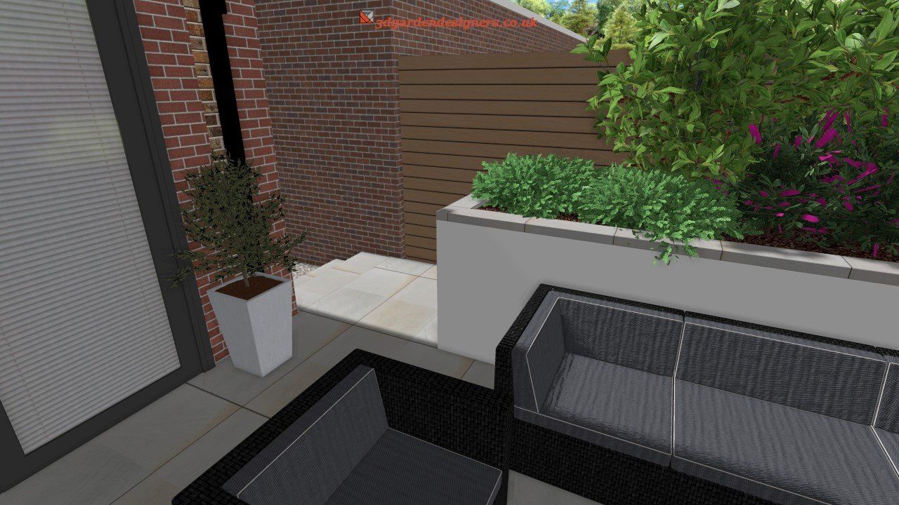 Patio with black furniture, white planter, brick wall, and green plants.