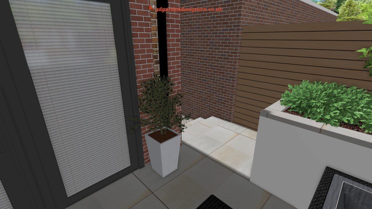 Outdoor patio area with white planter, brick wall, and wooden fence.