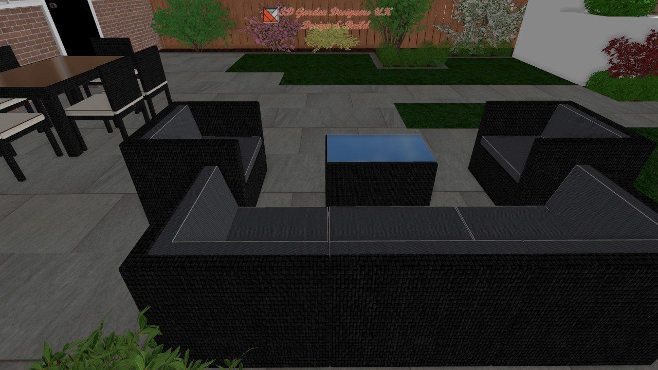 Patio furniture: black sofa, chairs, and coffee table on a stone patio; adjacent dining table.