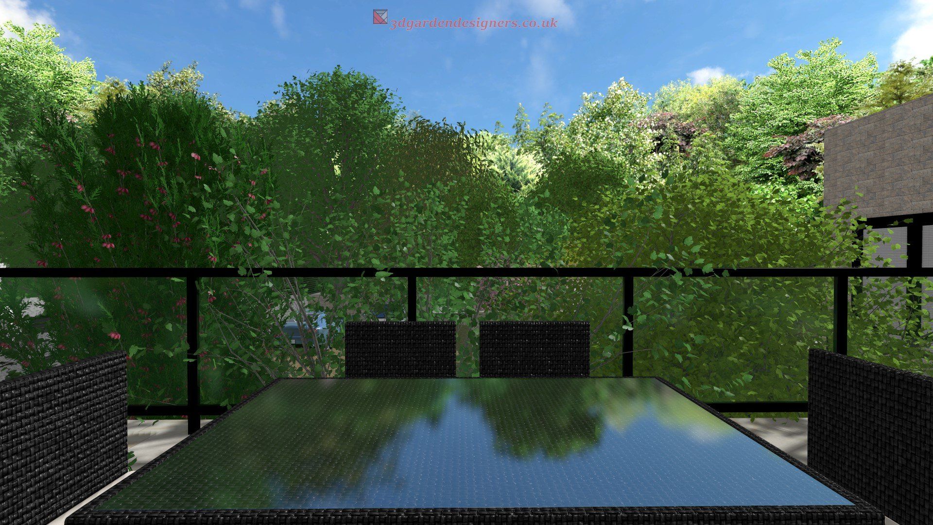 Outdoor patio with a table and chairs, overlooking a lush green treeline and a blue sky.