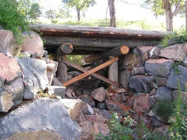 short bridge next to large rocks