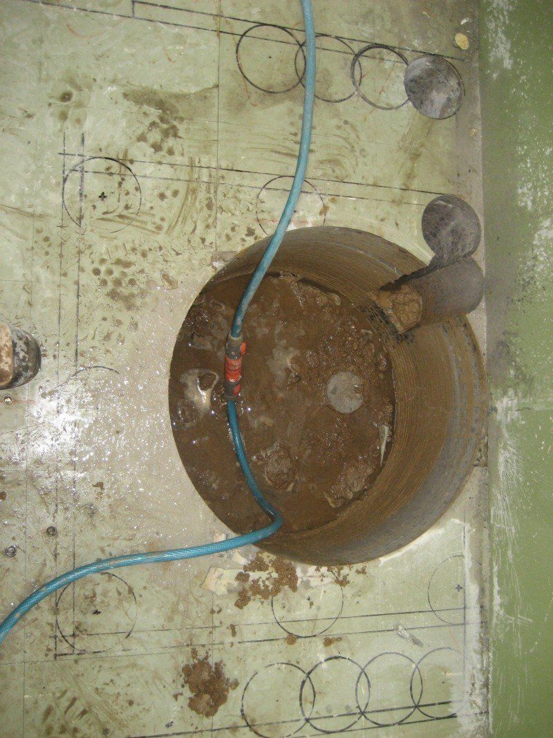 Big round hole being cut in bathroom floor