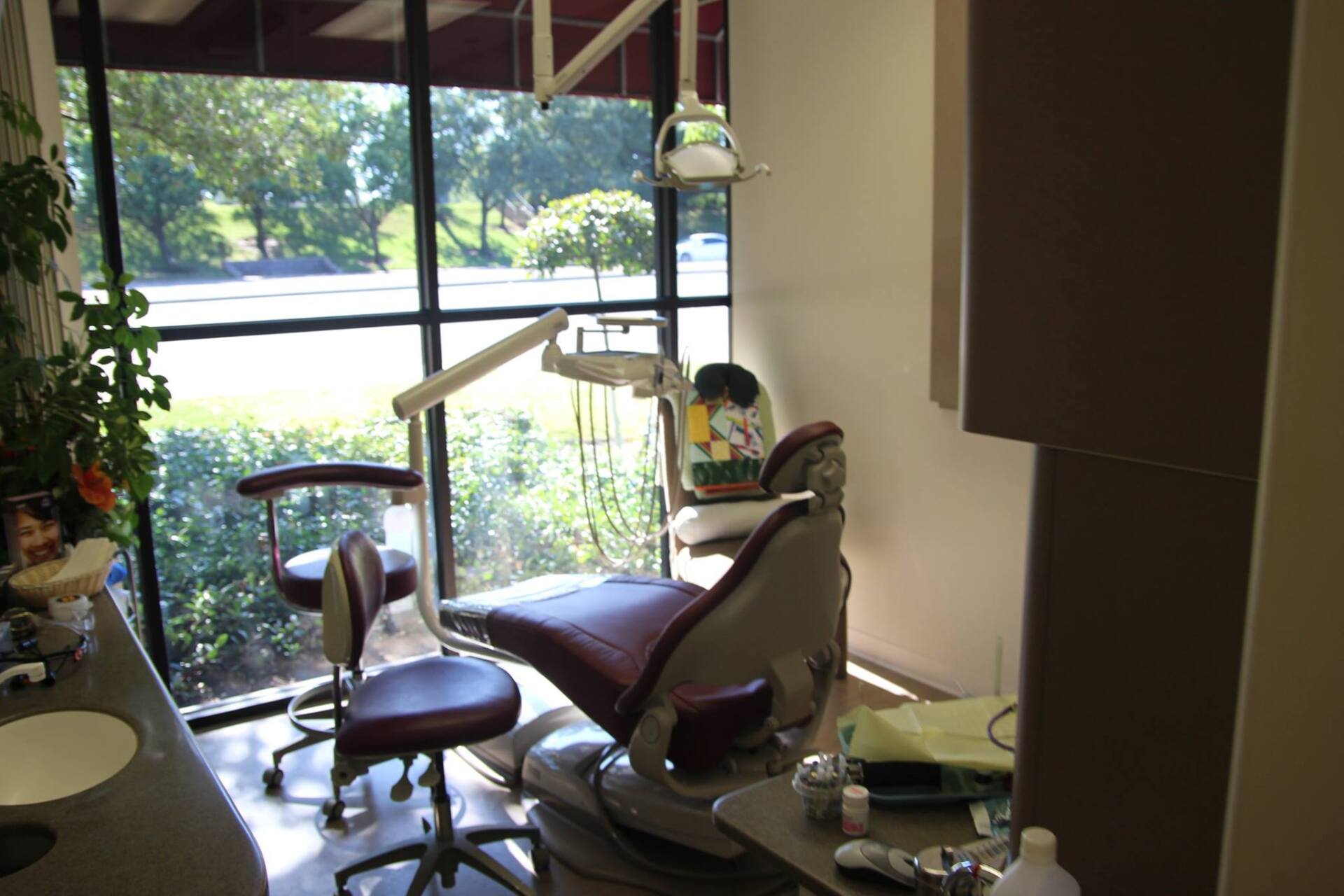 A dental office with a purple chair and a large window