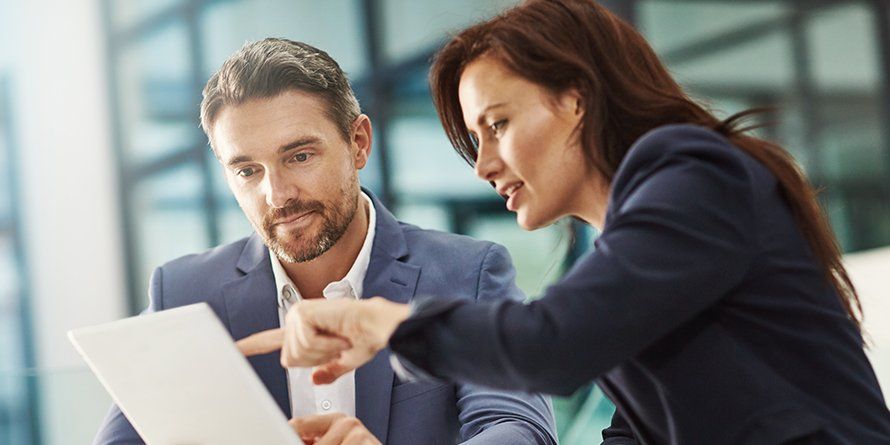 A female real estate agent goes over statements with an investor
