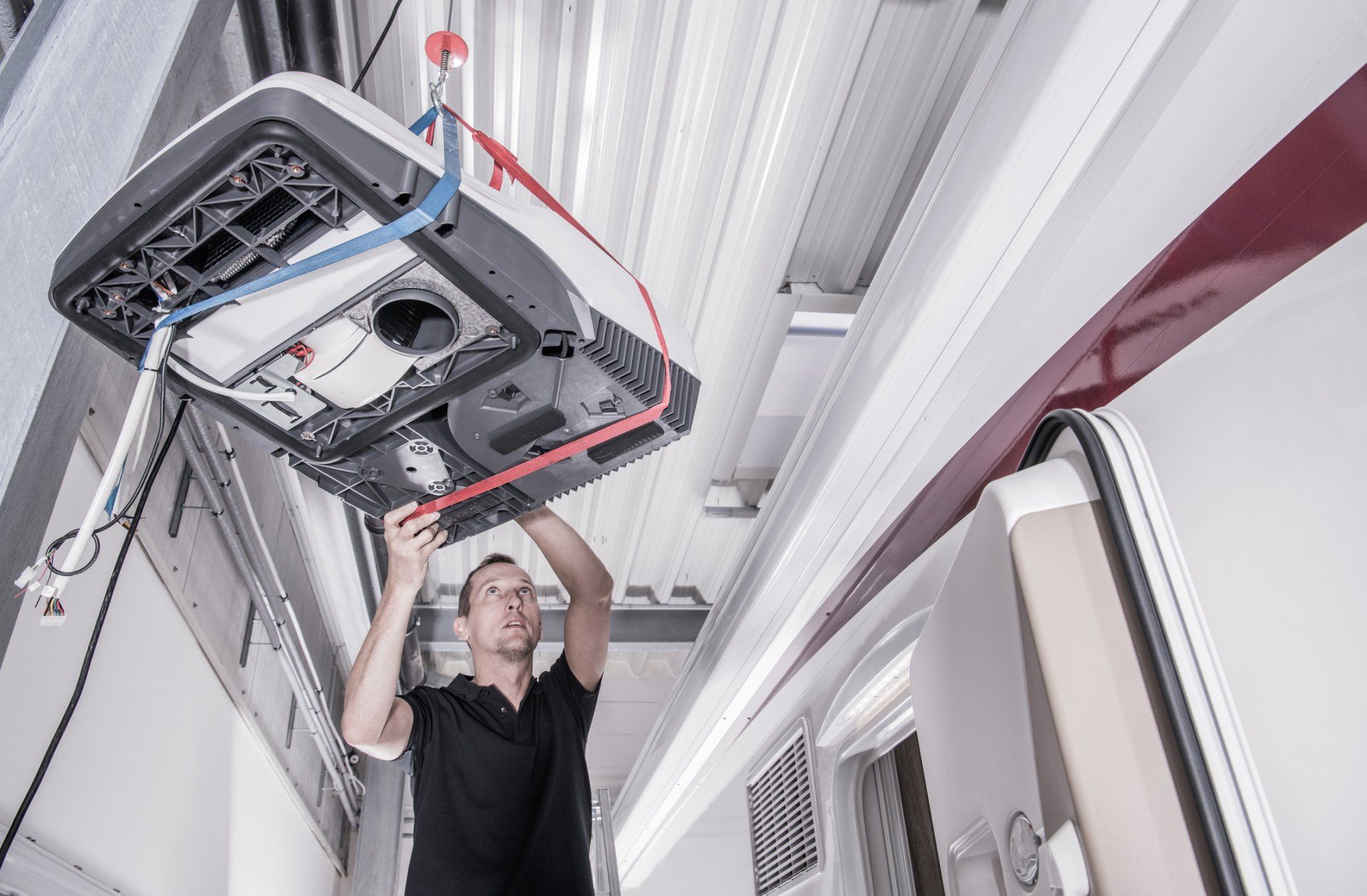 Man Repairing RV Air-condition – De Forest, WI – Custom RV Services