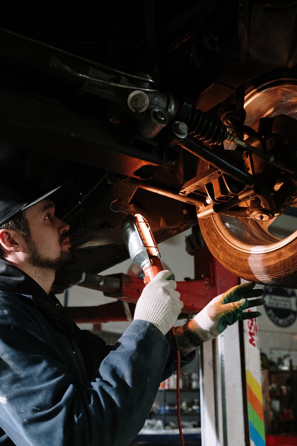 Auto Mechanic Working In Garage — Spray Painter in Park Avenue, QLD