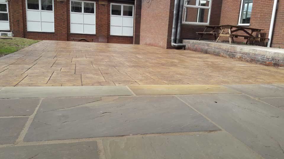 A brick building with a picnic table in front of it