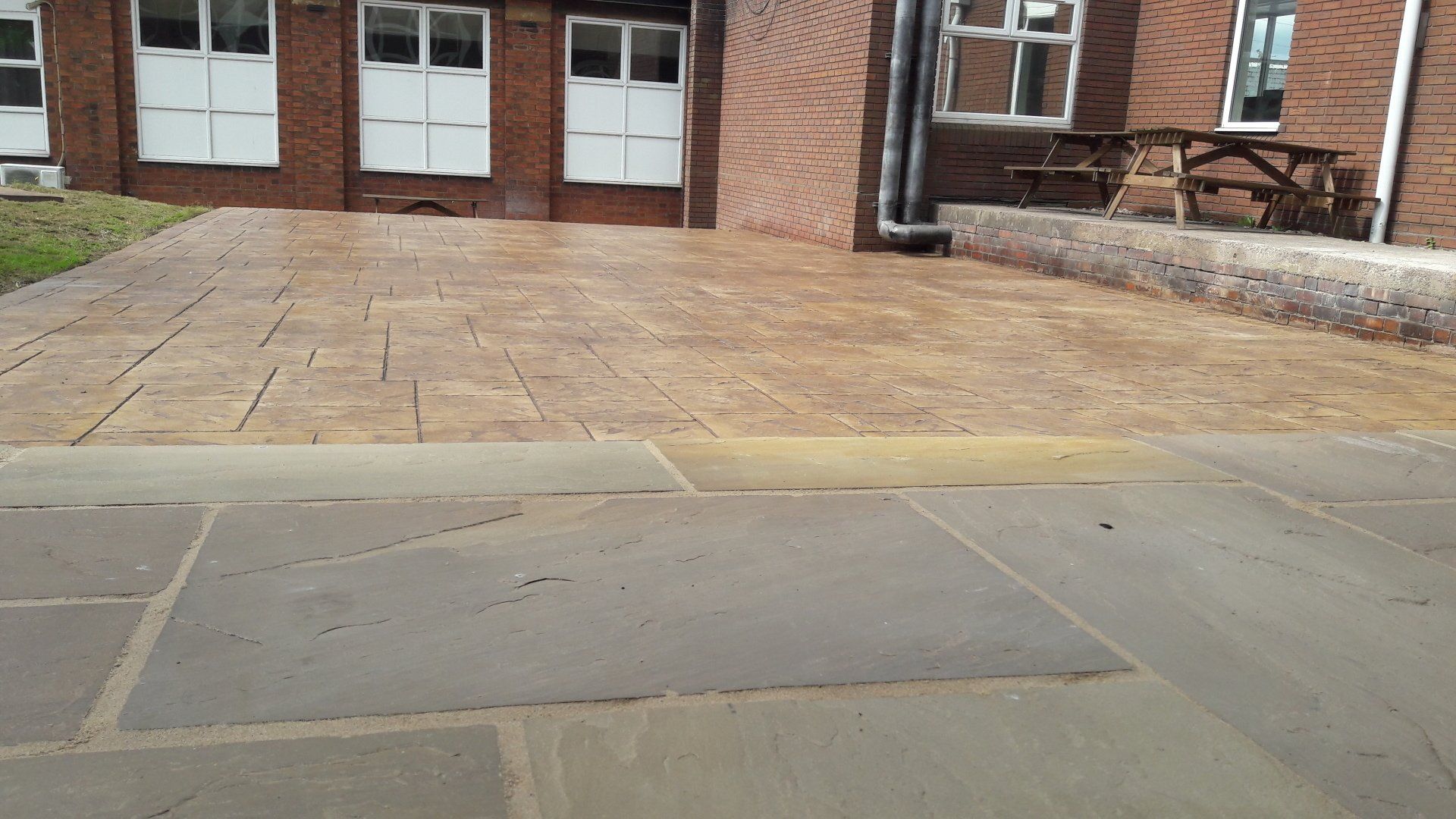 A brick building with a driveway in front of it