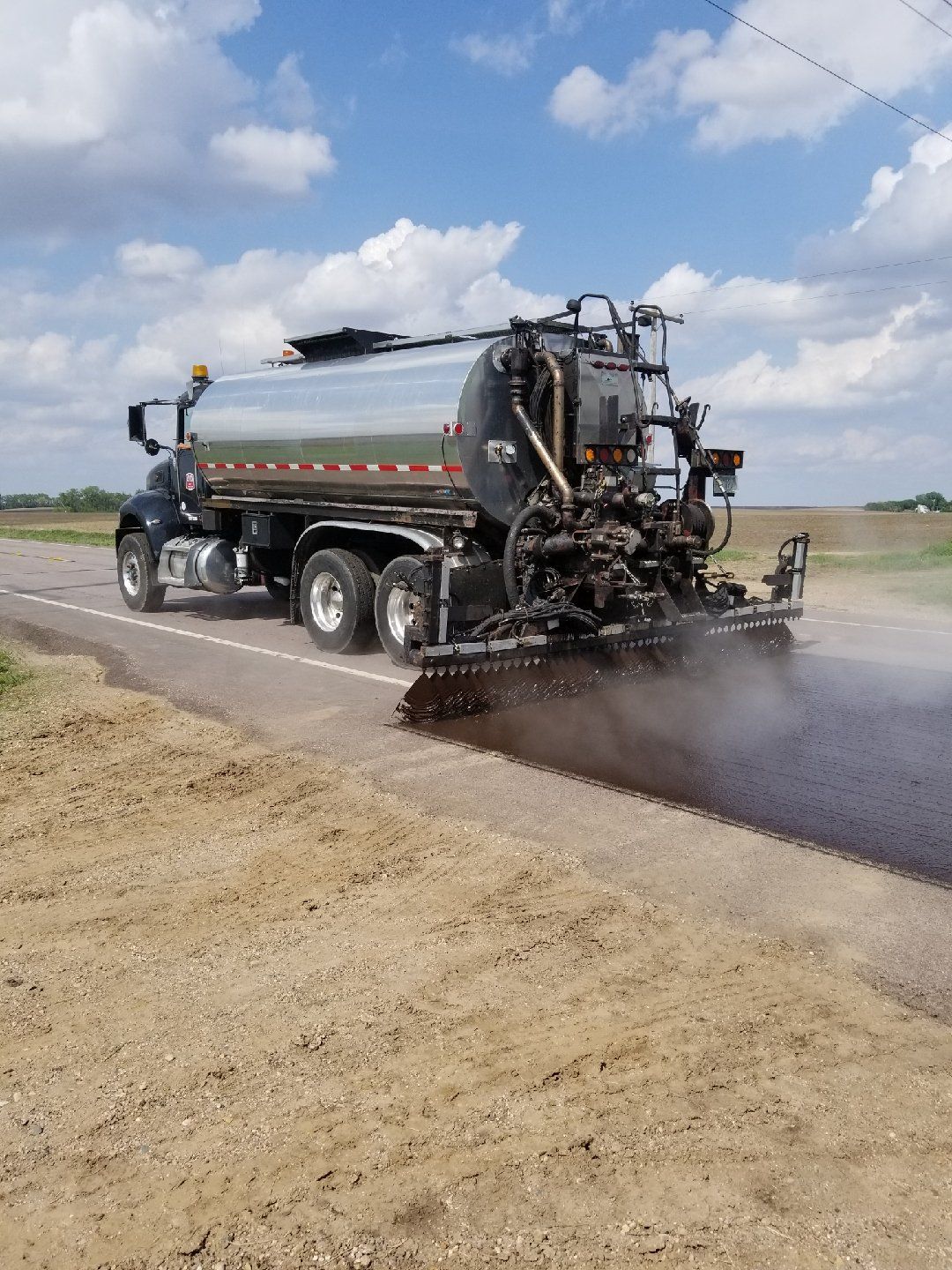 Asphalt Sealing — Chip Seal By Truck in Saint Joseph, MN