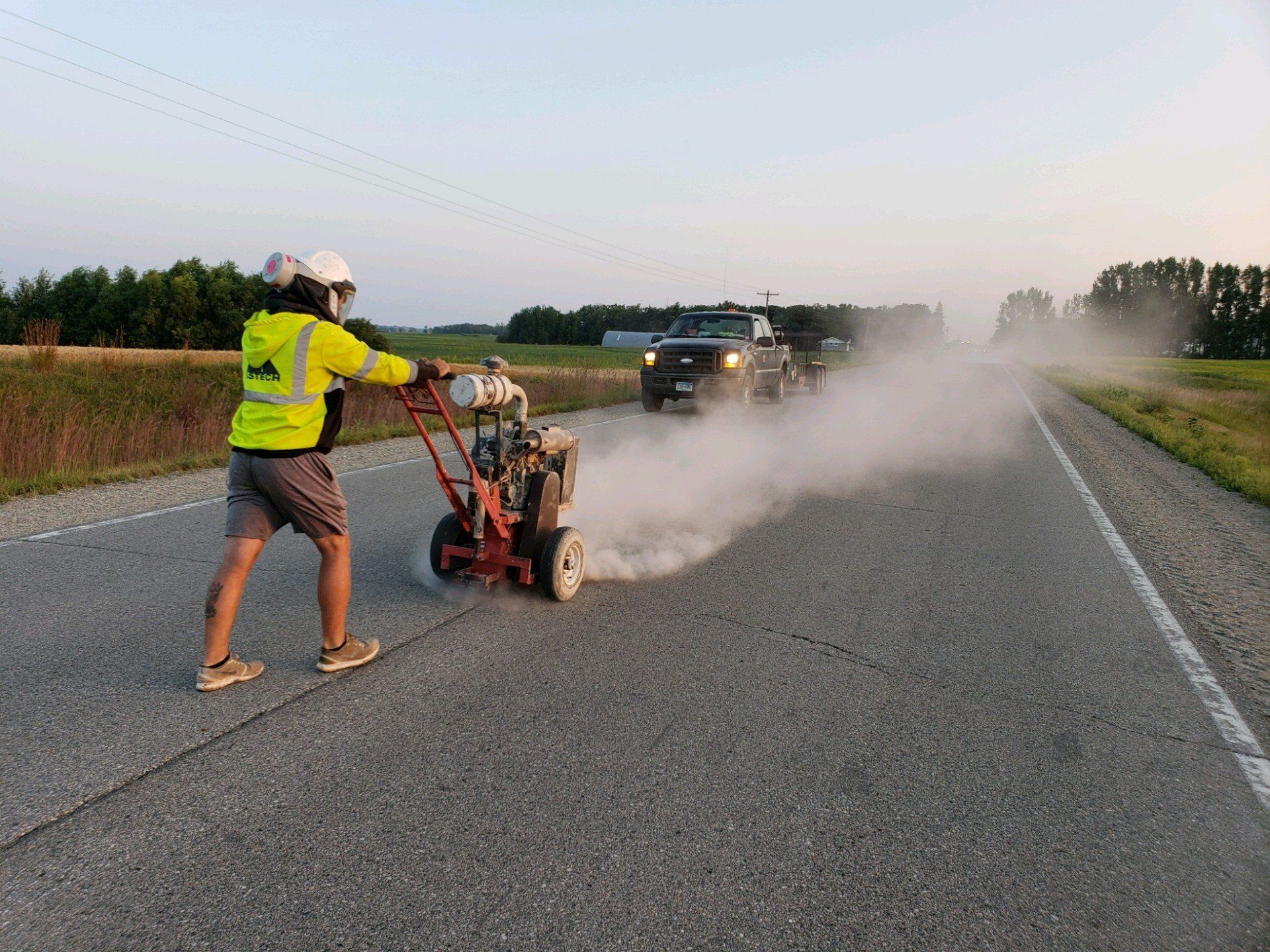 Asphalt Repairing — Man Using Paving Equipment in Saint Joseph, MN