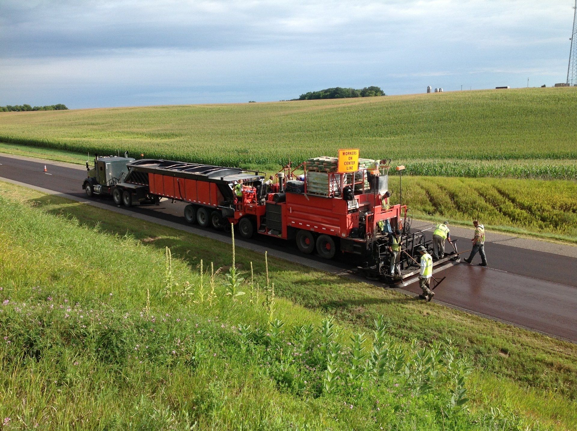 Asphalt Installation — Workers Paving The Road in Saint Joseph, MN
