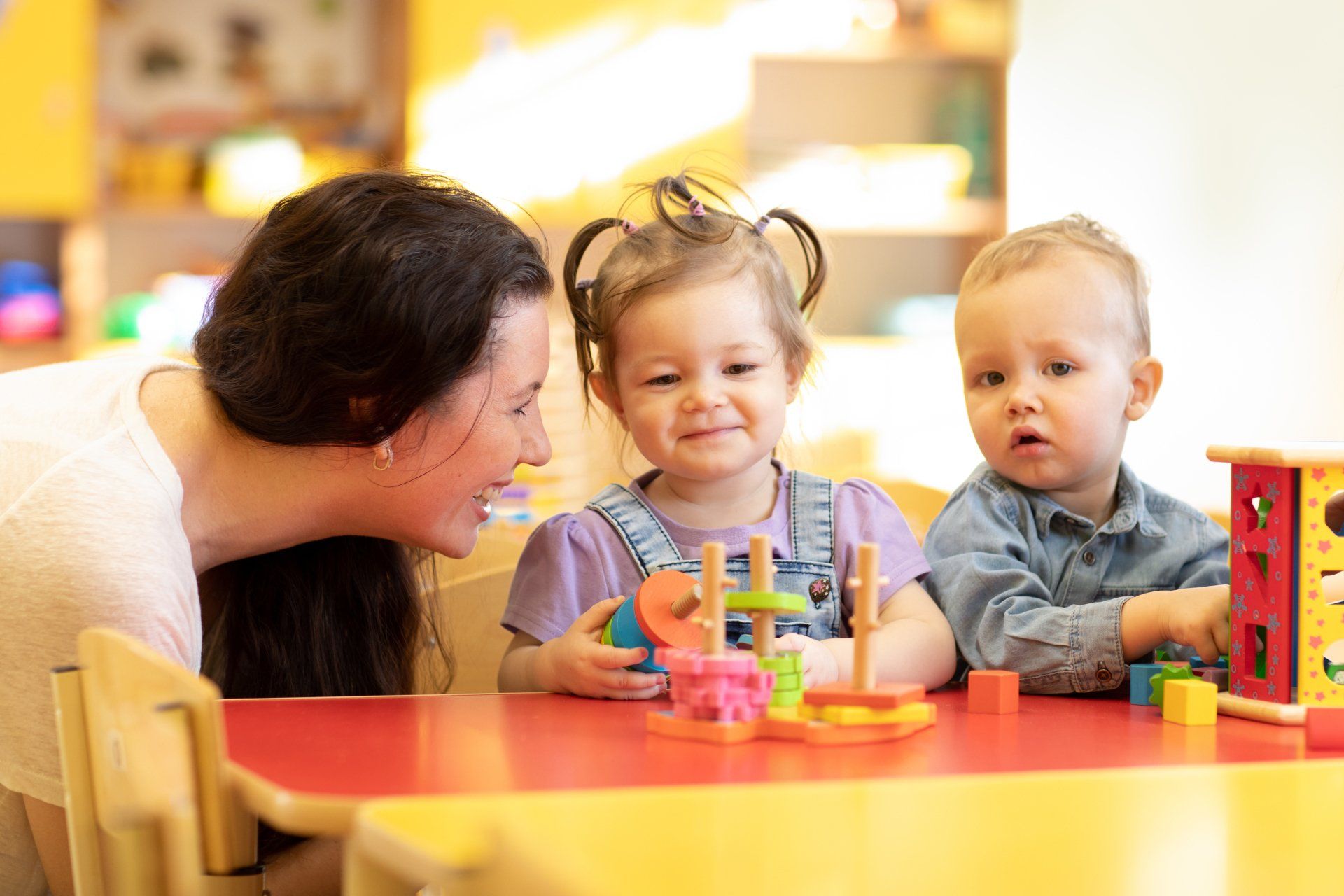 Smiling Preschool Teacher and Happy Students