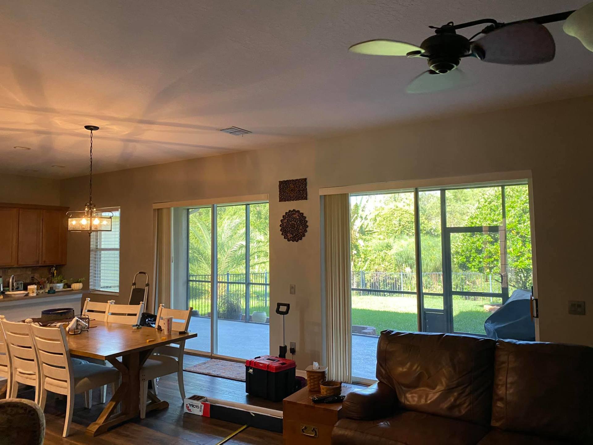 Open living and dining room with large sliding glass doors to a green backyard.