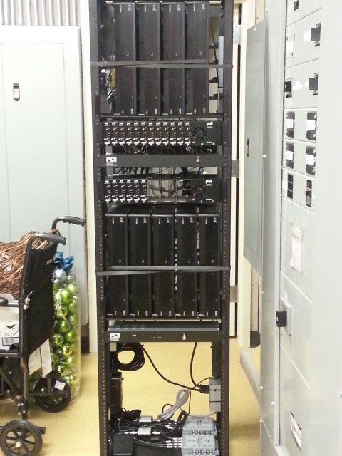 A wheelchair sits in front of a server rack