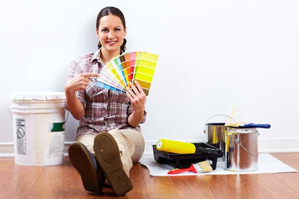 Beautiful woman with painting roller