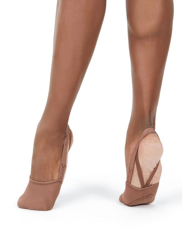 A close up of a person 's feet wearing brown tights.