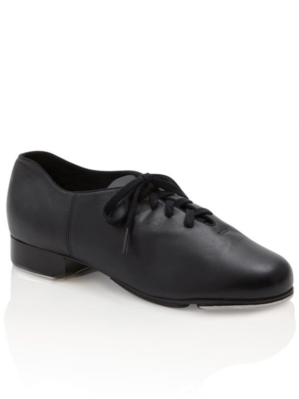 A pair of black lace up dance shoes on a white surface.