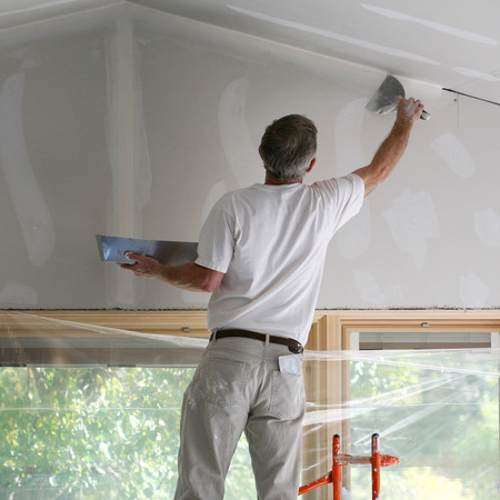 Applying mud to freshly taped sheetrock.