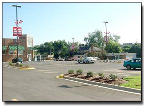 Quality Control Testing — Meridian, MS — Engineering Plus, Inc. A parking area in front of a building with cars and greenery; light poles with banners.