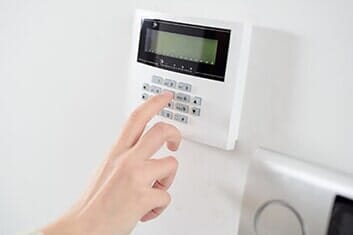 Woman's hand entering code on keypad — Access Control in Baltimore, MD