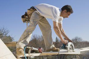 Carpenter Cutting Plank - Home Improvement in Salisbury, MD Carpenter Cutting Plank - Home Improvement in Salisbury, MD