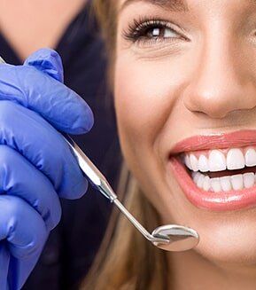 BOTOX® Cosmetic — Dentist Checking Teeth of Patient in Mansfield, OH BOTOX® Cosmetic — Dentist Checking Teeth of Patient in Mansfield, OH