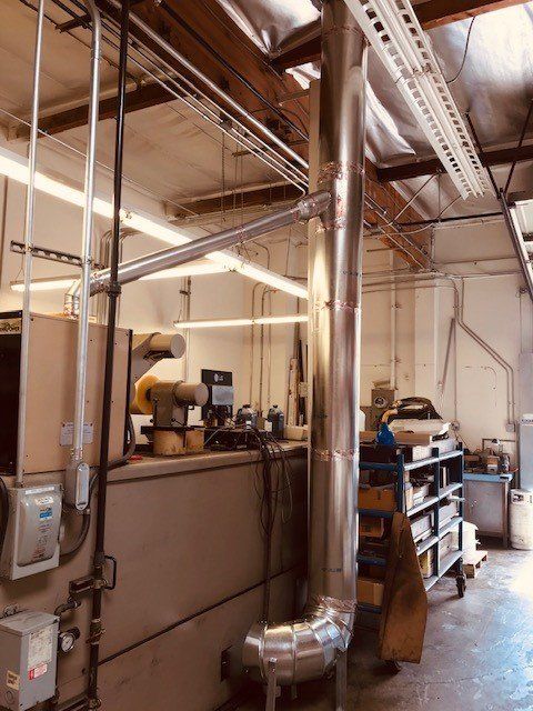 Plumber Working On Central Heating Boiler — Huntington Beach, CA — Amm Air Conditioning & Heating Plumber Working On Central Heating Boiler — Huntington Beach, CA — Amm Air Conditioning & Heating