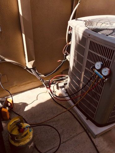 HVAC Tech Working On A Condensing Unit — Huntington Beach, CA — Amm Air Conditioning & Heating HVAC Tech Working On A Condensing Unit — Huntington Beach, CA — Amm Air Conditioning & Heating