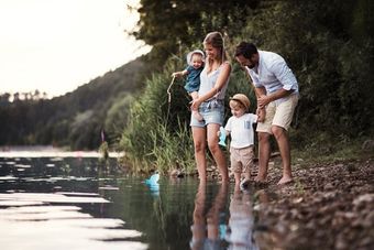 family standing by water