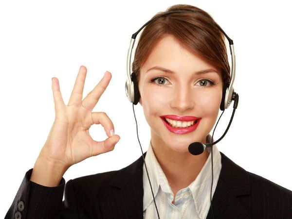 Woman with headset, smiling, making an