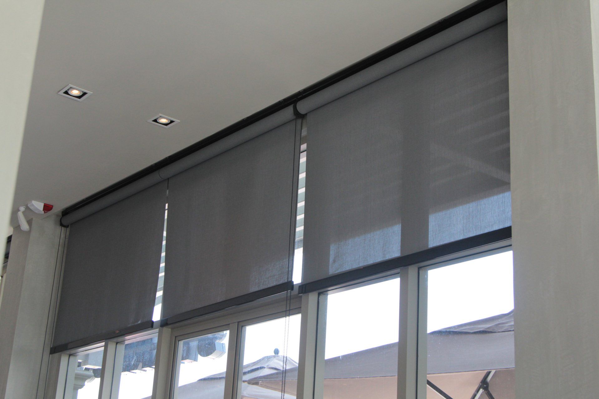 Grey Transparent Roller Blinds On Window — Custom Blinds & Flooring in Caboolture, QLD