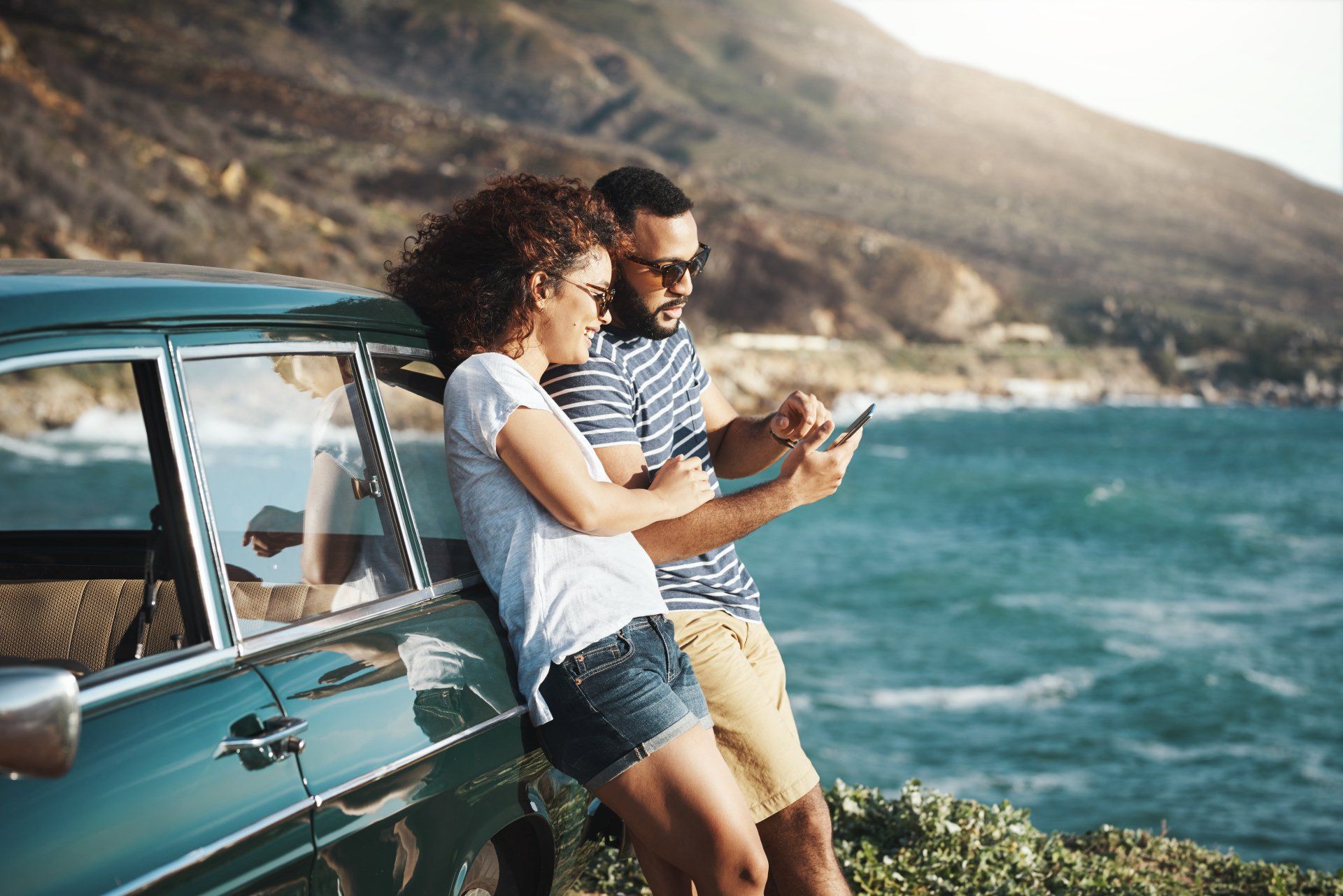 Photo of a couple by the beach. Go to dashboard.appfoliowebsites.com (contact subpage)