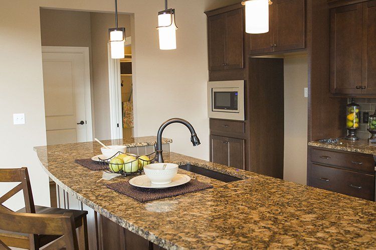 Dark Brown Cabinets & Kitchen Counter by Hansman Custom Homes in Mid-Missouri