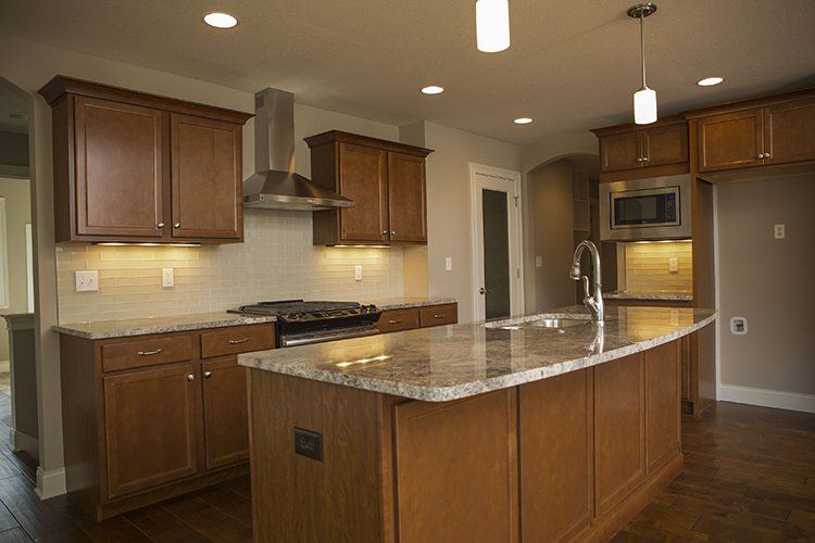Shiny Darkwood Kitchen by Hansman Custom Homes in Mid-Missouri