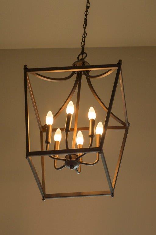 Cozy Hanging Light in Dark Room by Hansman Custom Homes in Mid-MO