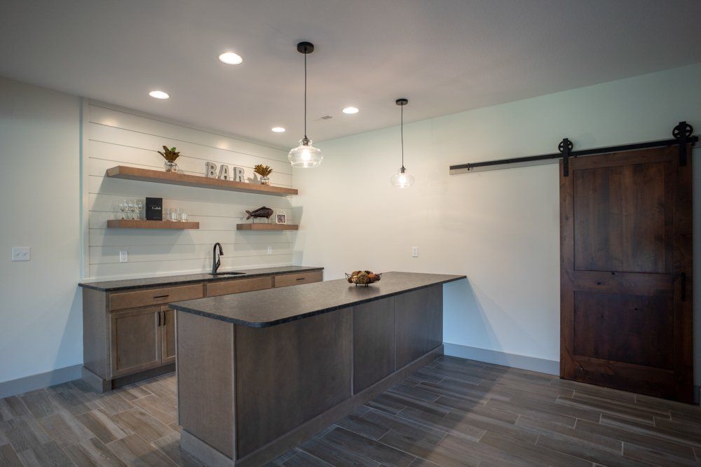 Decorated Minimalist Wet Bar by Hansman Custom Homes in Mid-MO