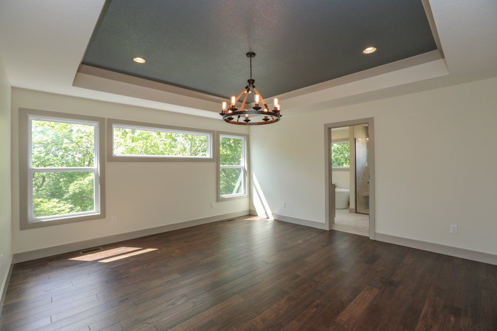 A Sunny Room With a Chandelier by Hansman Custom Homes in Mid-MO