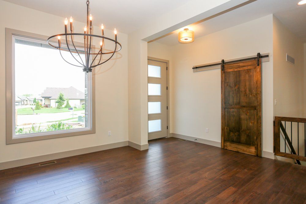 Upstairs Space With Chandelier & Windows by Hansman Custom Homes in Mid-MO