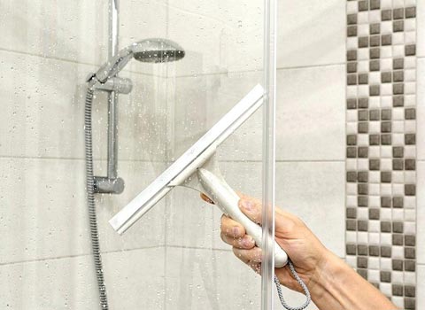 A Glass Being Clean With A Wiper Tool — Champaign, IL — RDI Properties A Glass Being Clean With A Wiper Tool — Champaign, IL — RDI Properties