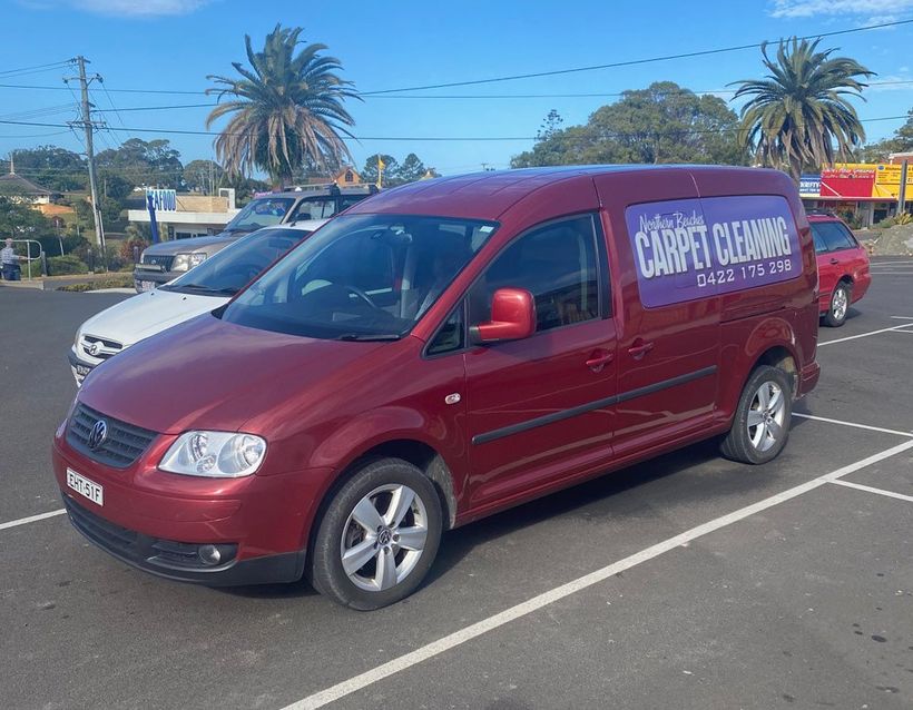 Red Car With Business Signage — Carpet Cleaning in Coffs Harbour Red Car With Business Signage — Carpet Cleaning in Coffs Harbour