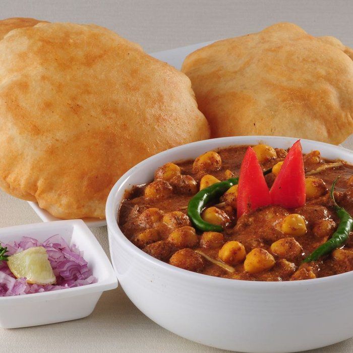 A bowl of food with a red pepper on top