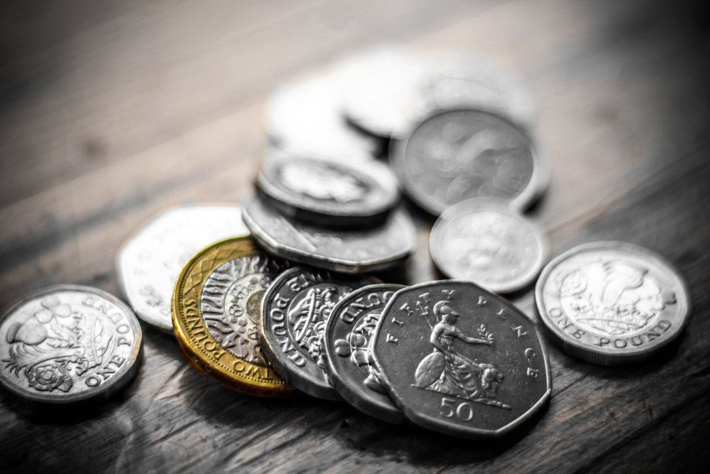 A fountain pen, calculator, silver and golden coins. Business,finance or investment concept.
