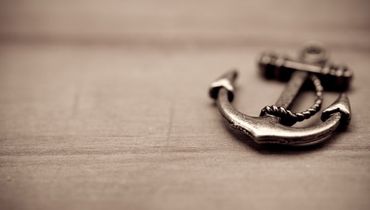 An anchor charm on a wood table