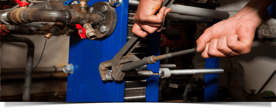 plumber fixing a commercial plumbing system